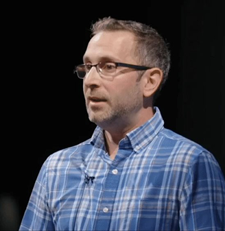 Speaker in a blue checkered shirt